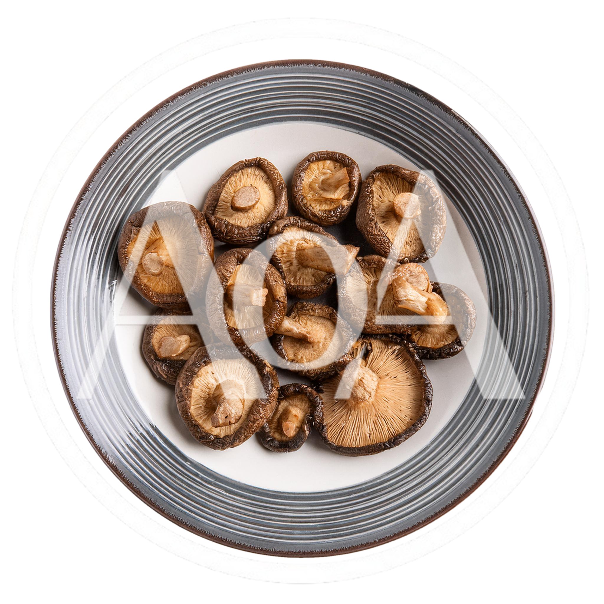 Fresh Shiitake Mushrooms Arranged On A Striped Plate