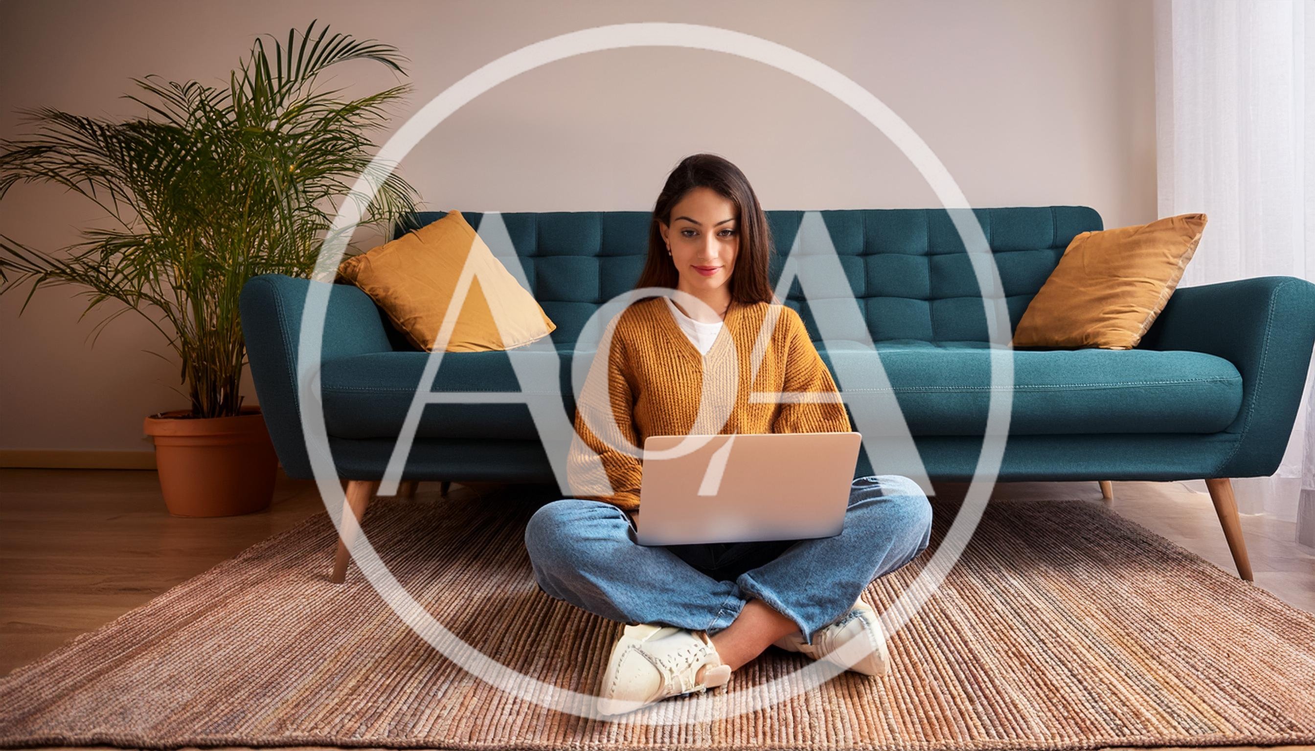 Young Woman Working on Laptop Sitting on Living Room Floor
