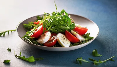 Fresh Caprese Salad with Arugula on Blue Background