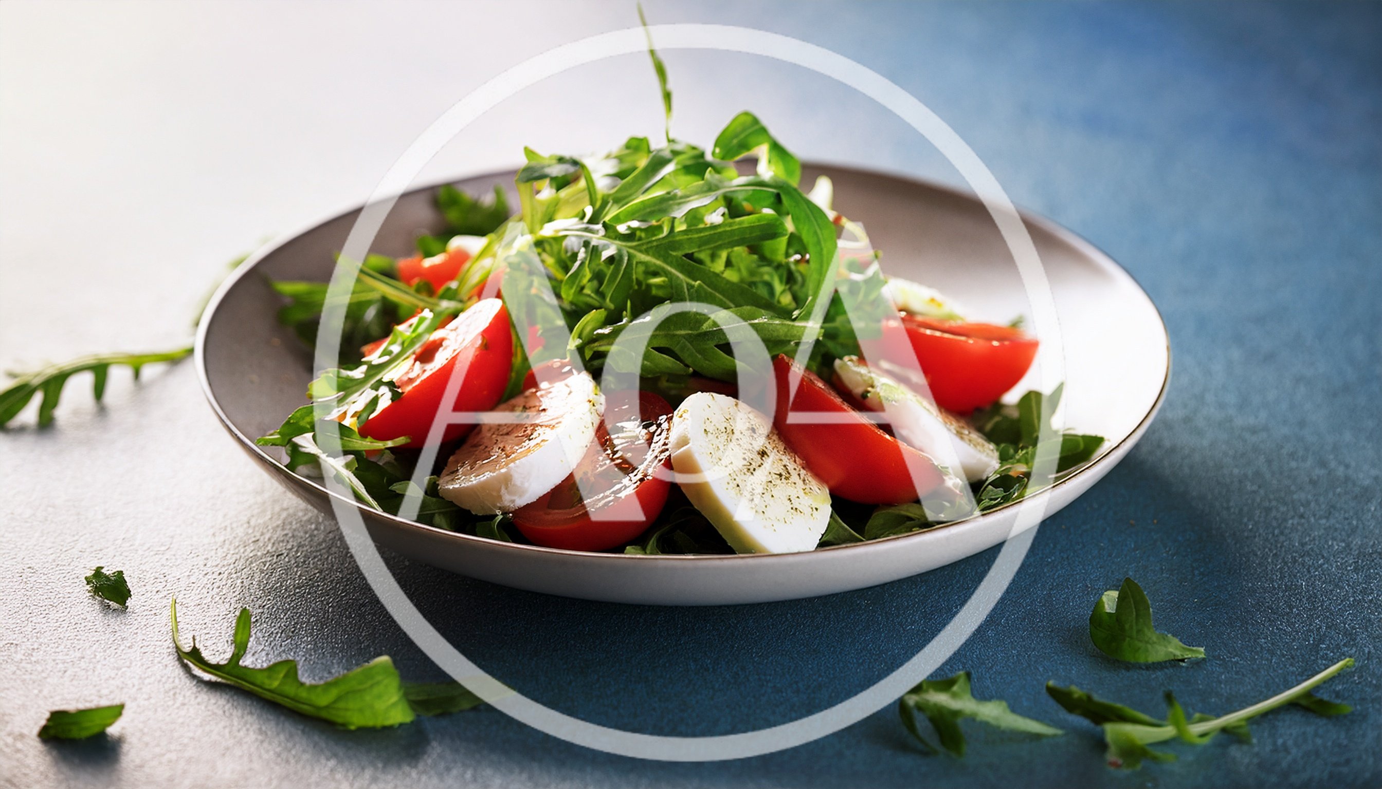 Fresh Caprese Salad with Arugula on Blue Background