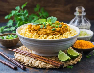 Bowl Of Curry Noodles With Lime And Herbs