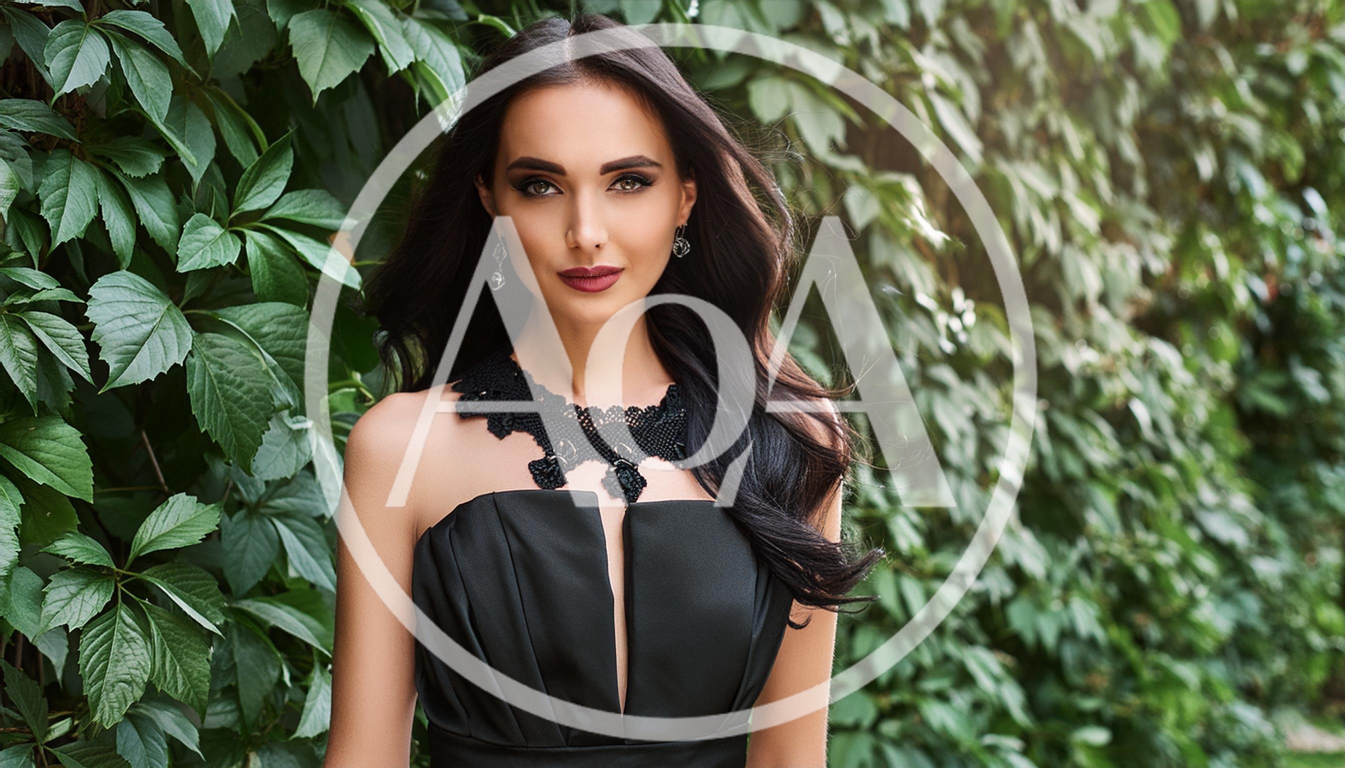 Elegant Woman In Black Dress Posing Outdoors