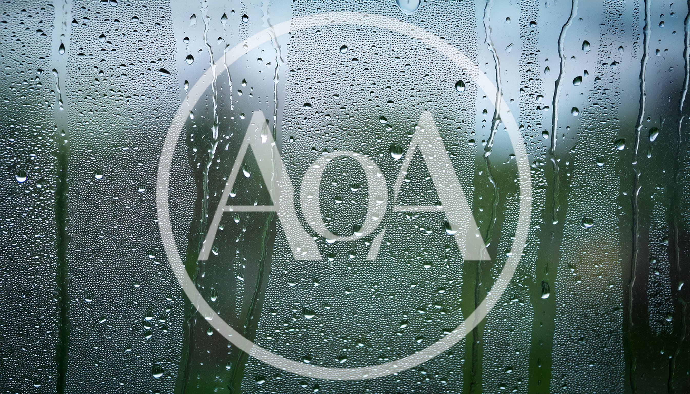 Raindrops Running Down A Glass Window Pane