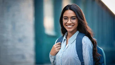 Smiling Female Student Wearing Glasses And Carrying Backpack
