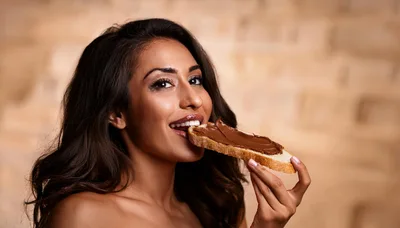 Beautiful Woman Eating Bread With Chocolate Spread