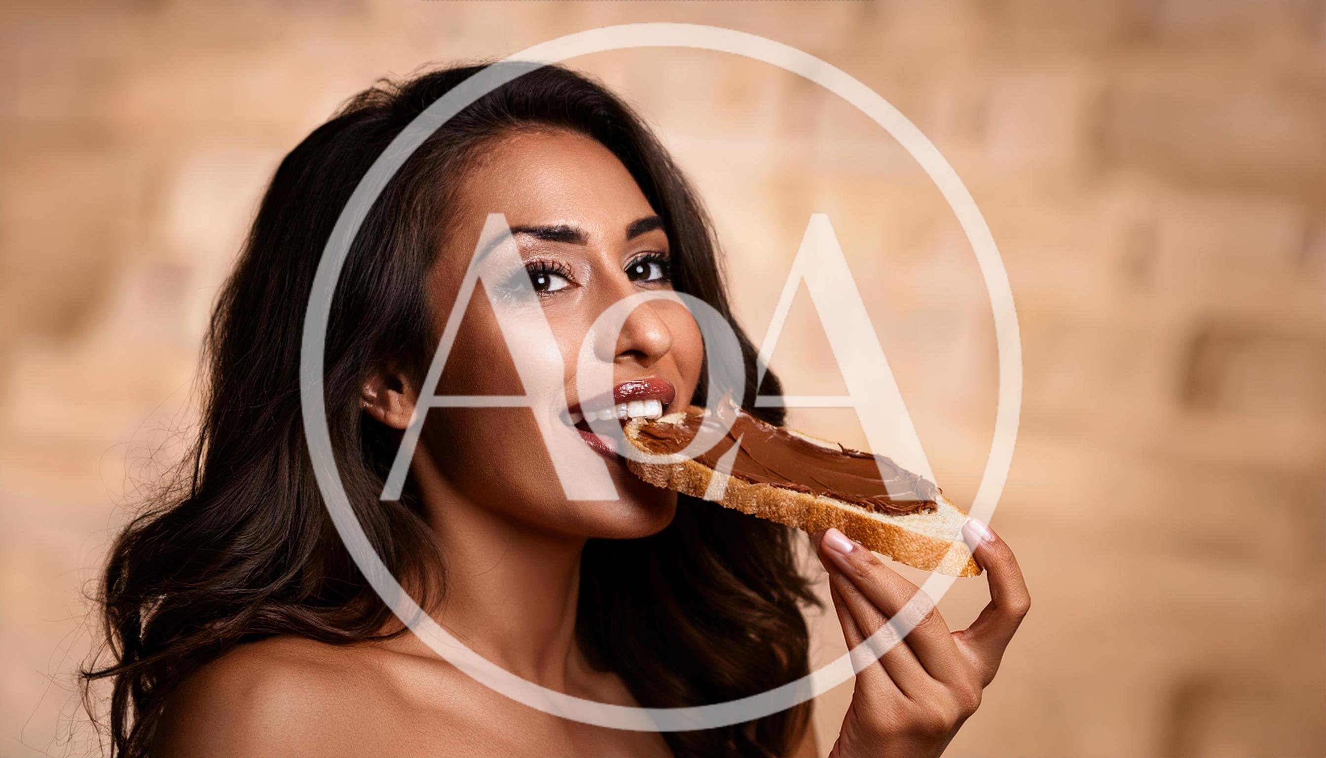 Beautiful Woman Eating Bread With Chocolate Spread