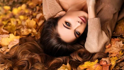 Beautiful Woman Lying In Autumn Leaves