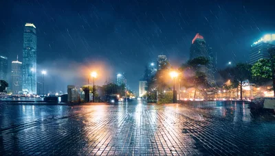 Rainy Night Cityscape With Wet Paved Waterfront Promenade
