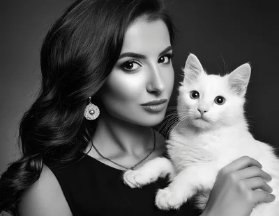 Elegant Woman Holding A Fluffy White Cat