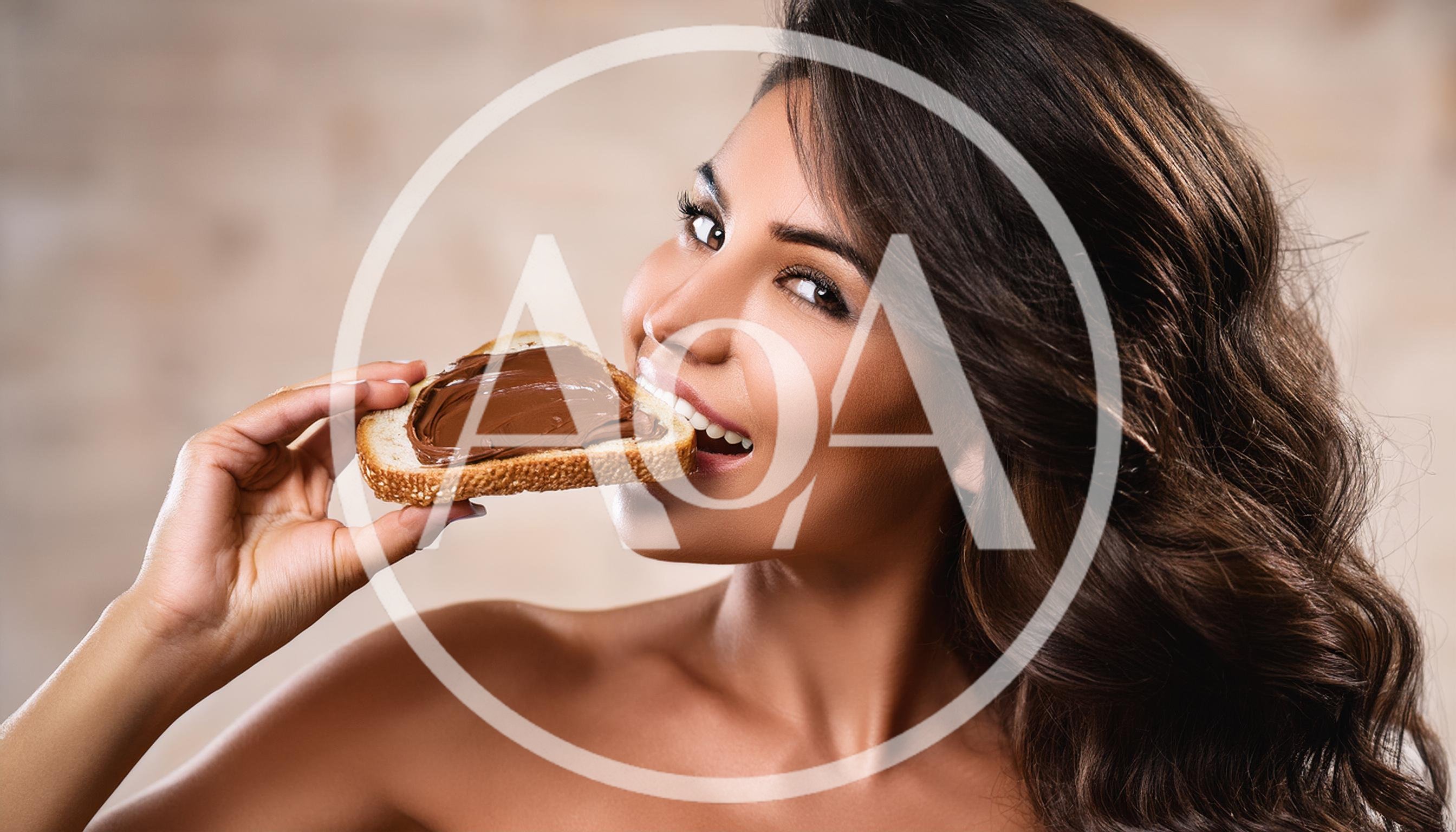 Beautiful Woman Eating Bread With Chocolate Spread
