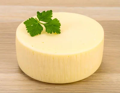 Round Wheel Of Fresh Yellow Cheese With Parsley