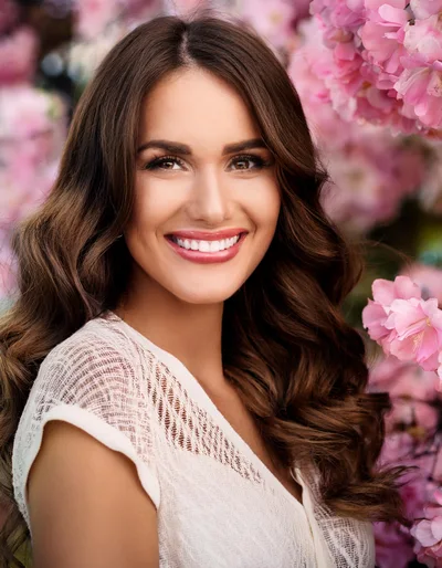Portrait Of A Smiling Woman Among Cherry Blossoms