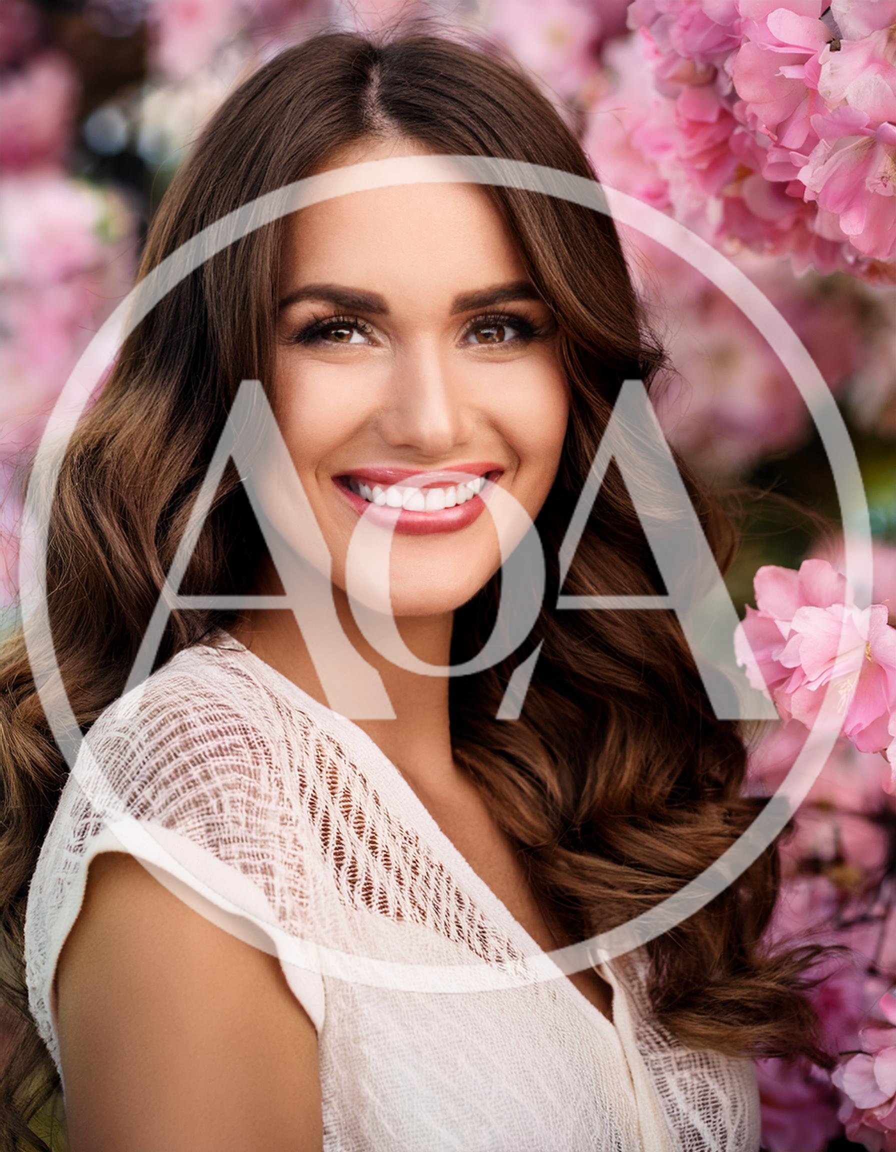 Portrait Of A Smiling Woman Among Cherry Blossoms