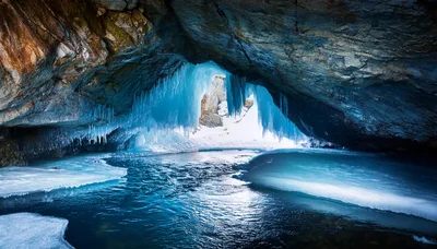 Frozen Ice Cave With Blue Icicles And Water
