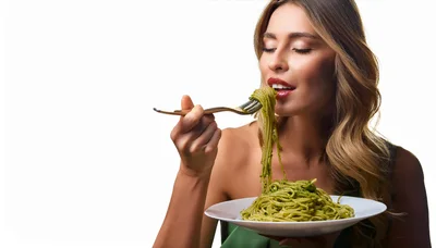 Woman Eating Pesto Pasta From A Fork