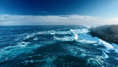 Aerial View Of Crashing Waves Against Rocky Coastline