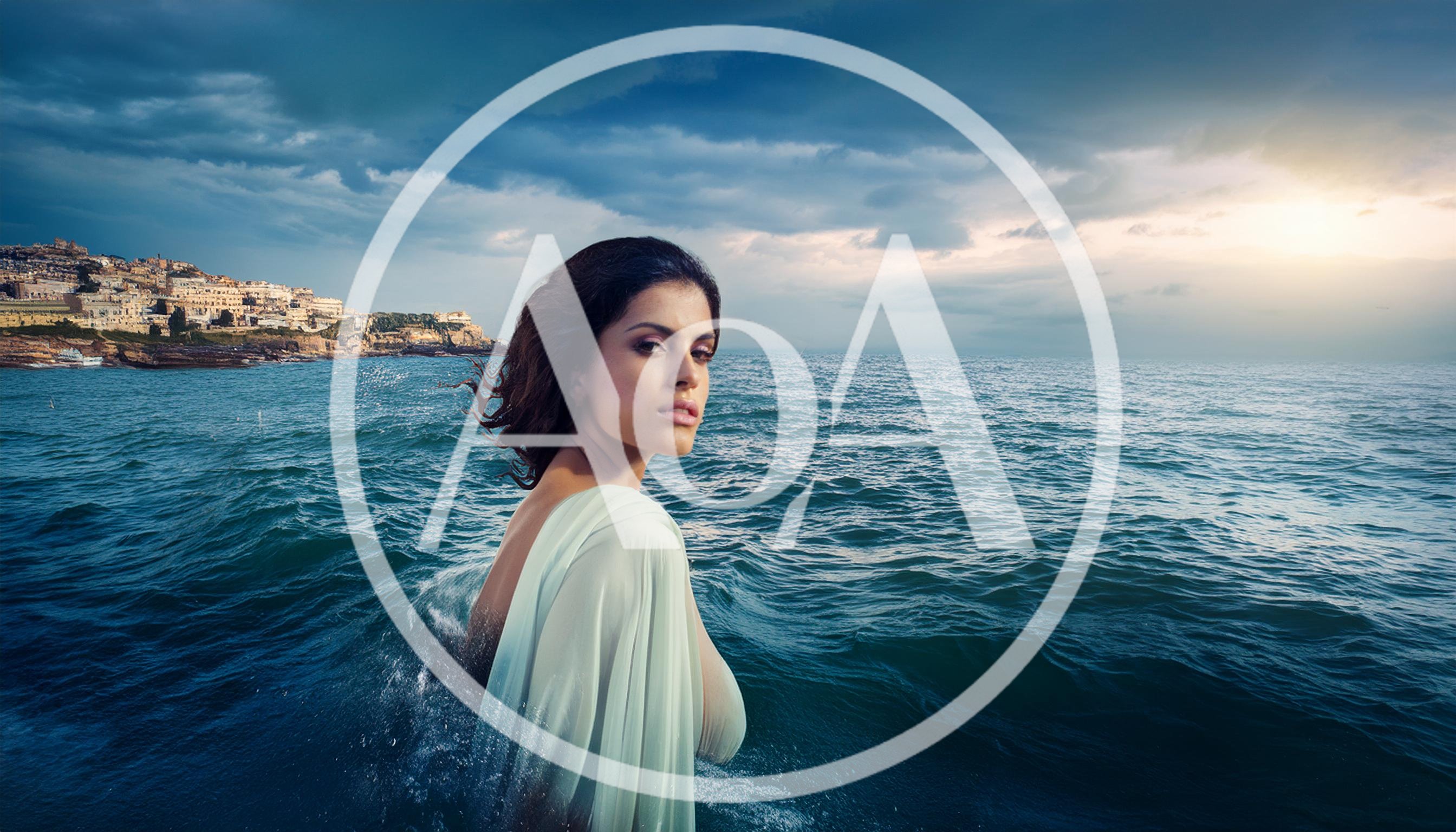 Woman In Flowing Dress Standing In The Ocean