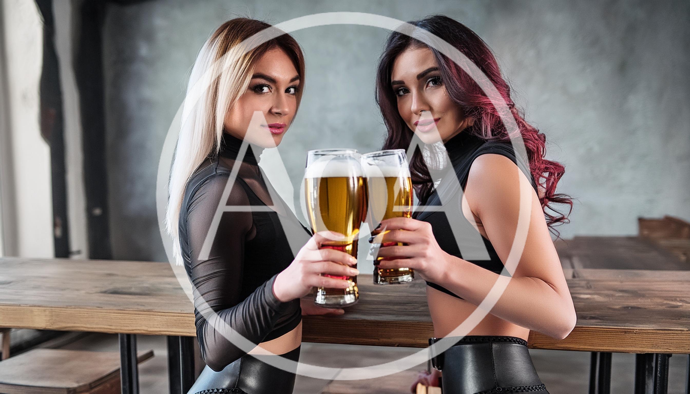 Two Attractive Women Toasting With Beer Glasses