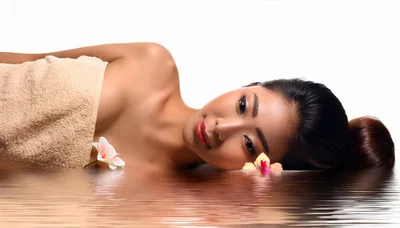 Beautiful Asian Woman Relaxing In A Spa Setting