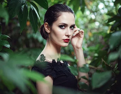 Elegant Woman Posing In Lush Green Foliage