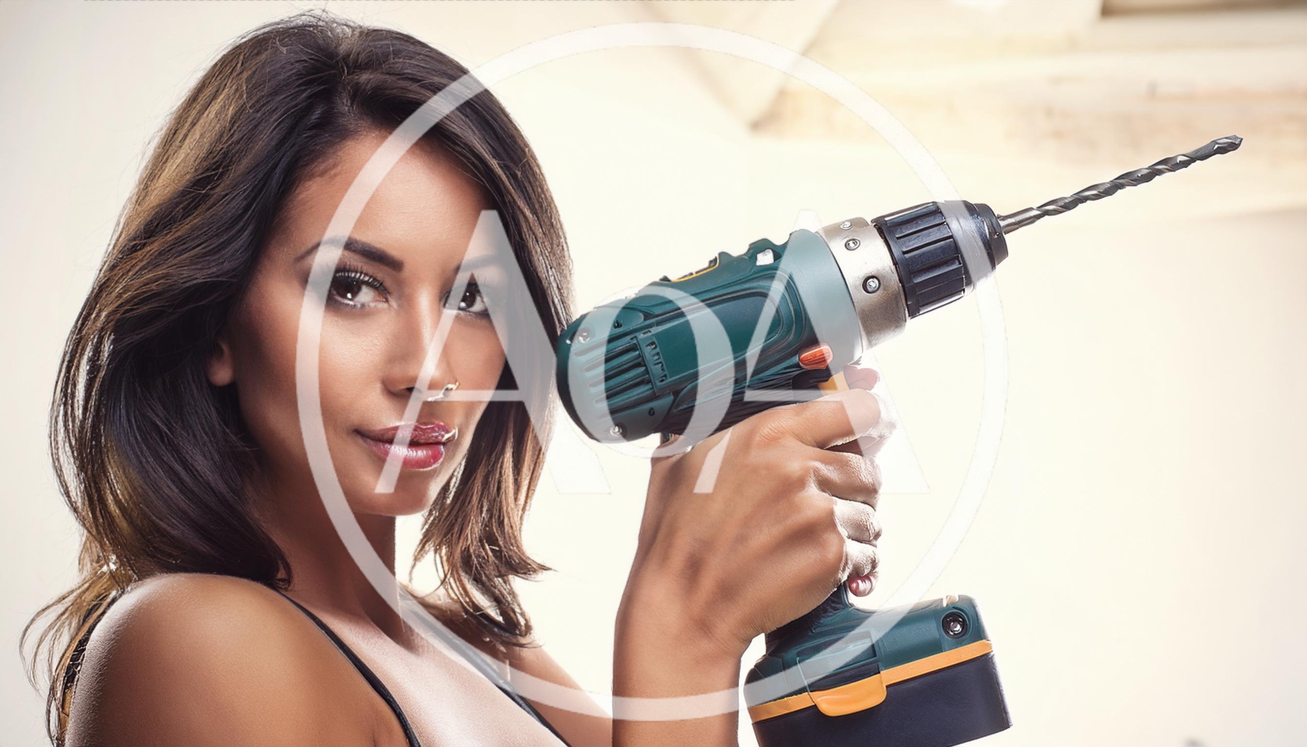 Beautiful Woman Holding A Power Drill