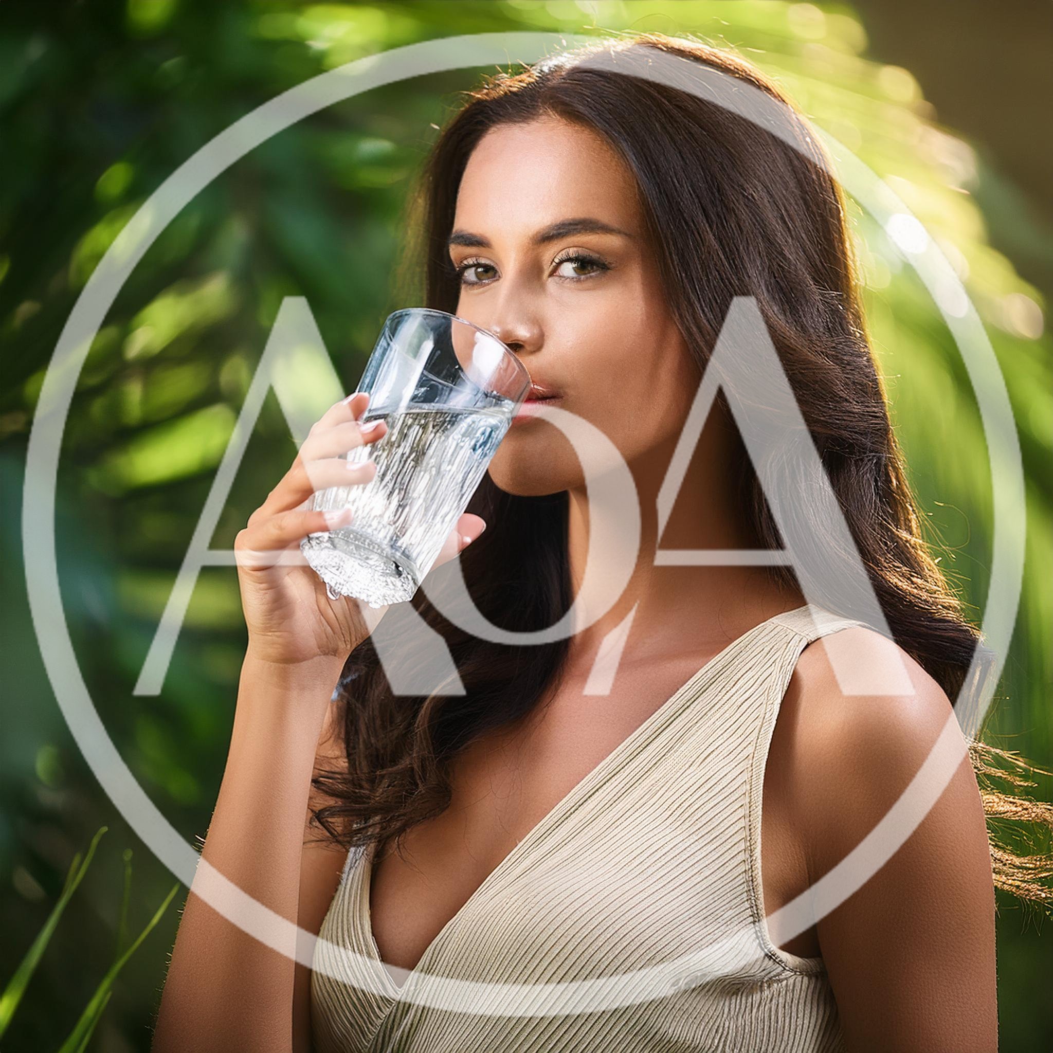 Young Woman Drinking Water in Tropical Garden