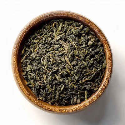 Dried Green Tea Leaves In A Wooden Bowl