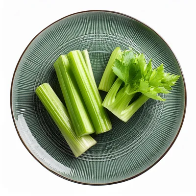 Fresh Celery Stalks Arranged On A Textured Green Plate