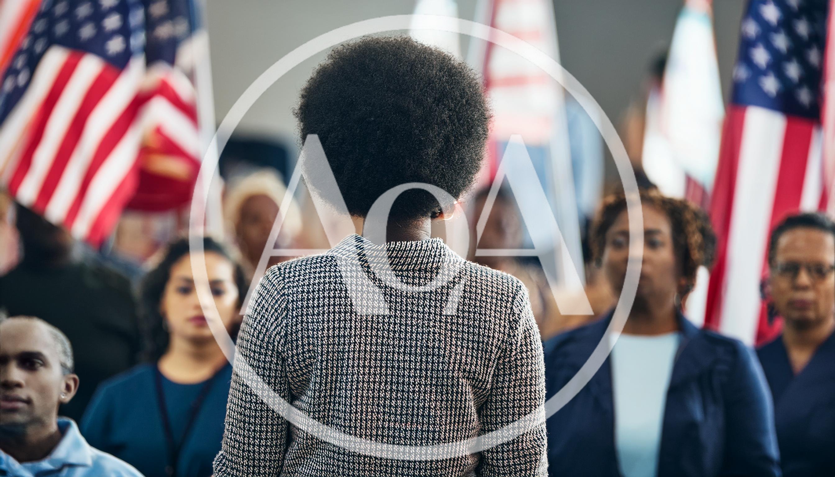 Diverse Group Standing Before American Flags