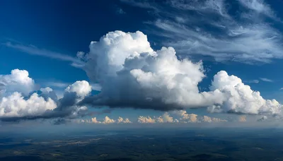 Aerial View Of Large Cumulus Clouds Over Landscape