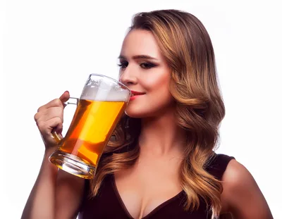 Young Woman Drinking Beer From A Glass Mug