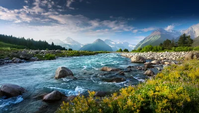 Scenic Mountain River Flowing Through A Lush Alpine Valley