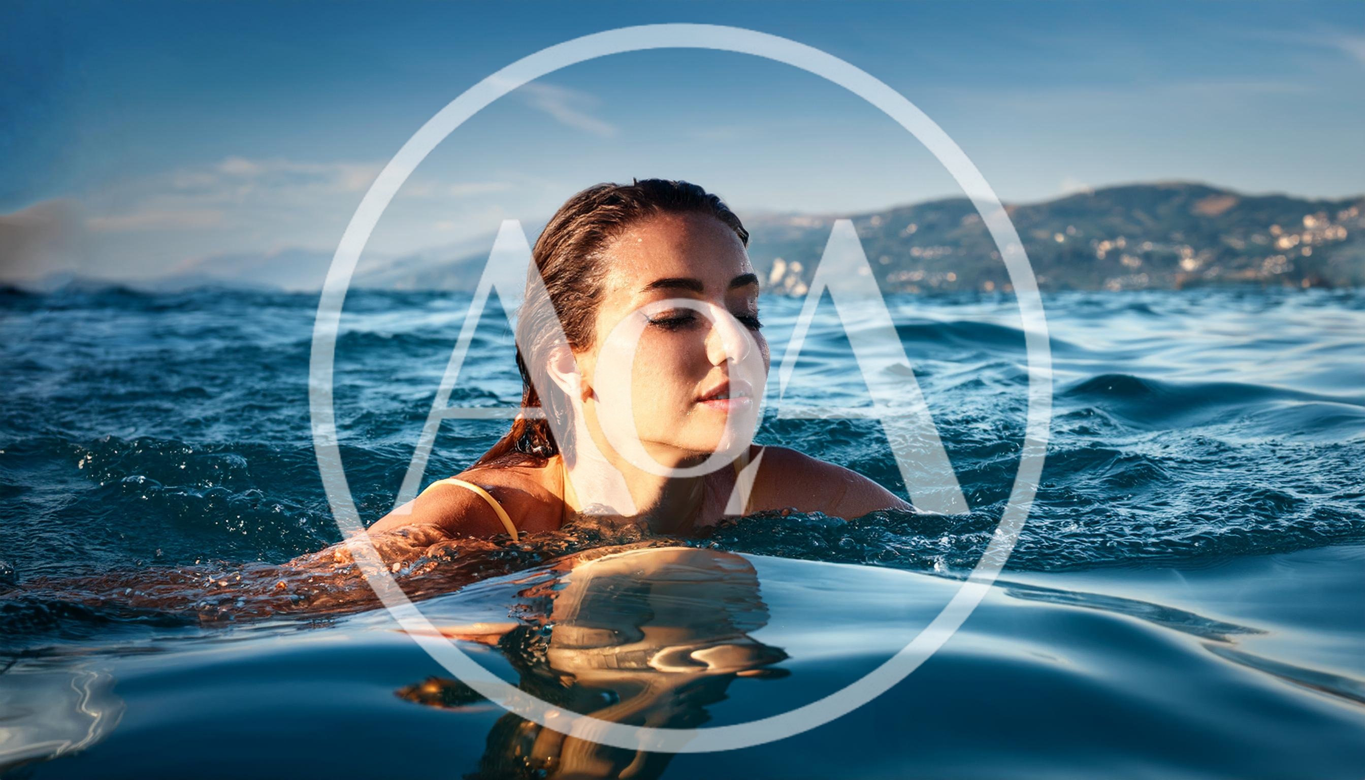 Young Woman Swimming In The Ocean At Sunset
