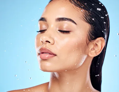 Young Woman With Wet Skin And Hair Under Water Spray