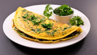 Fresh Herb Omelet Served On A White Plate
