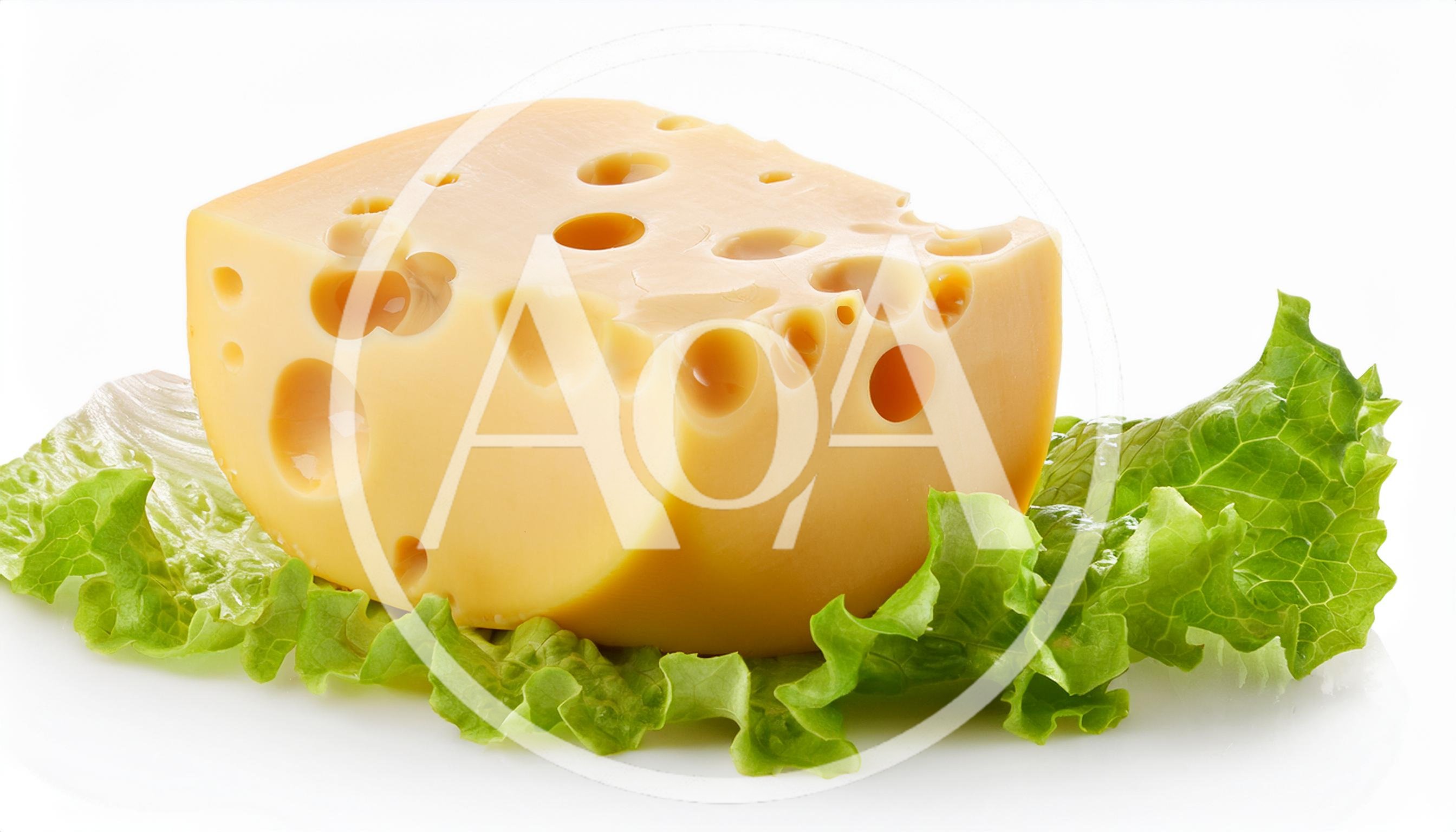 Block Of Swiss Cheese On Fresh Green Lettuce