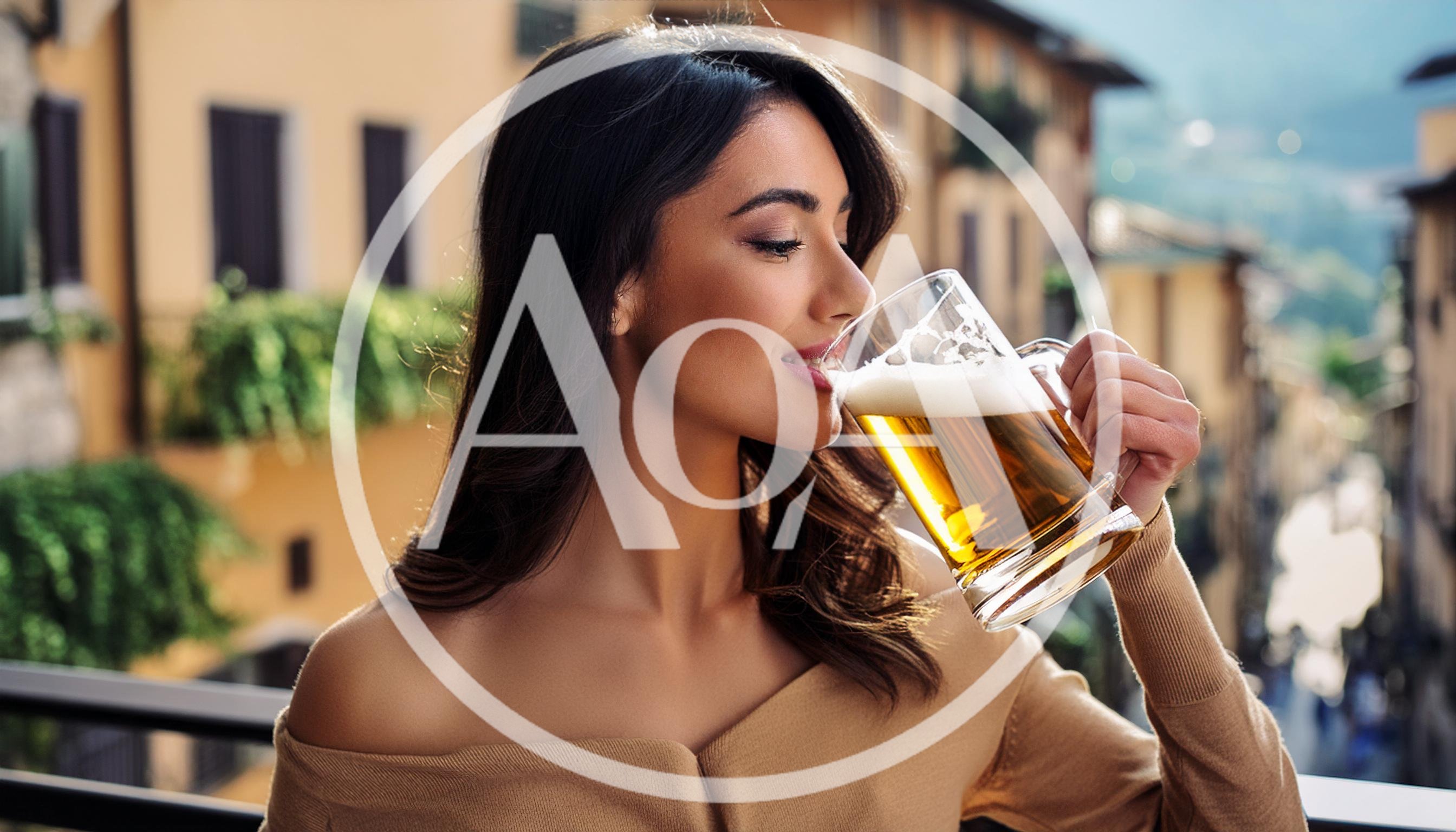 Young Woman Drinking Beer on a Sunny Balcony