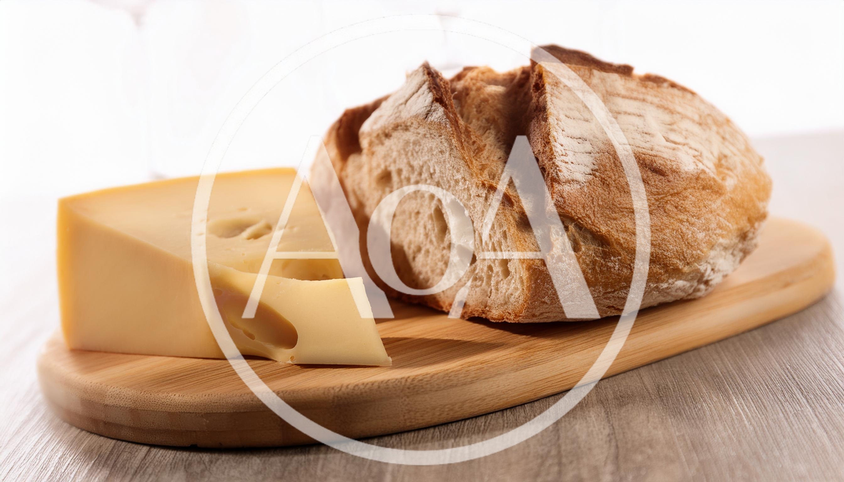 Wedge Of Swiss Cheese And Crusty Bread Loaf