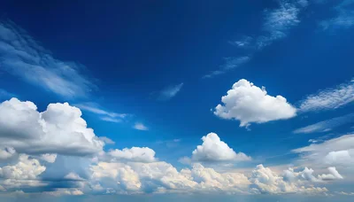 Fluffy White Cumulus Clouds Against A Deep Blue Sky