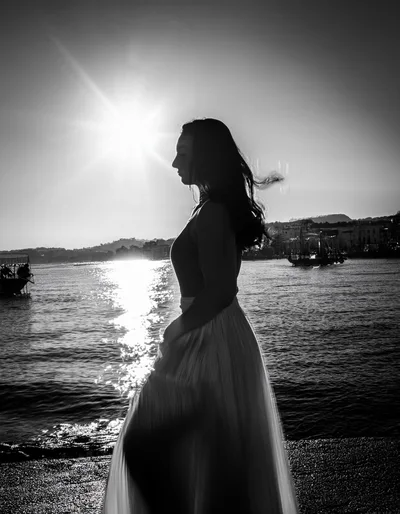 Silhouette Of A Woman Standing By The Sea