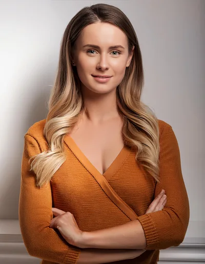 Portrait Of A Confident Woman In An Orange Sweater