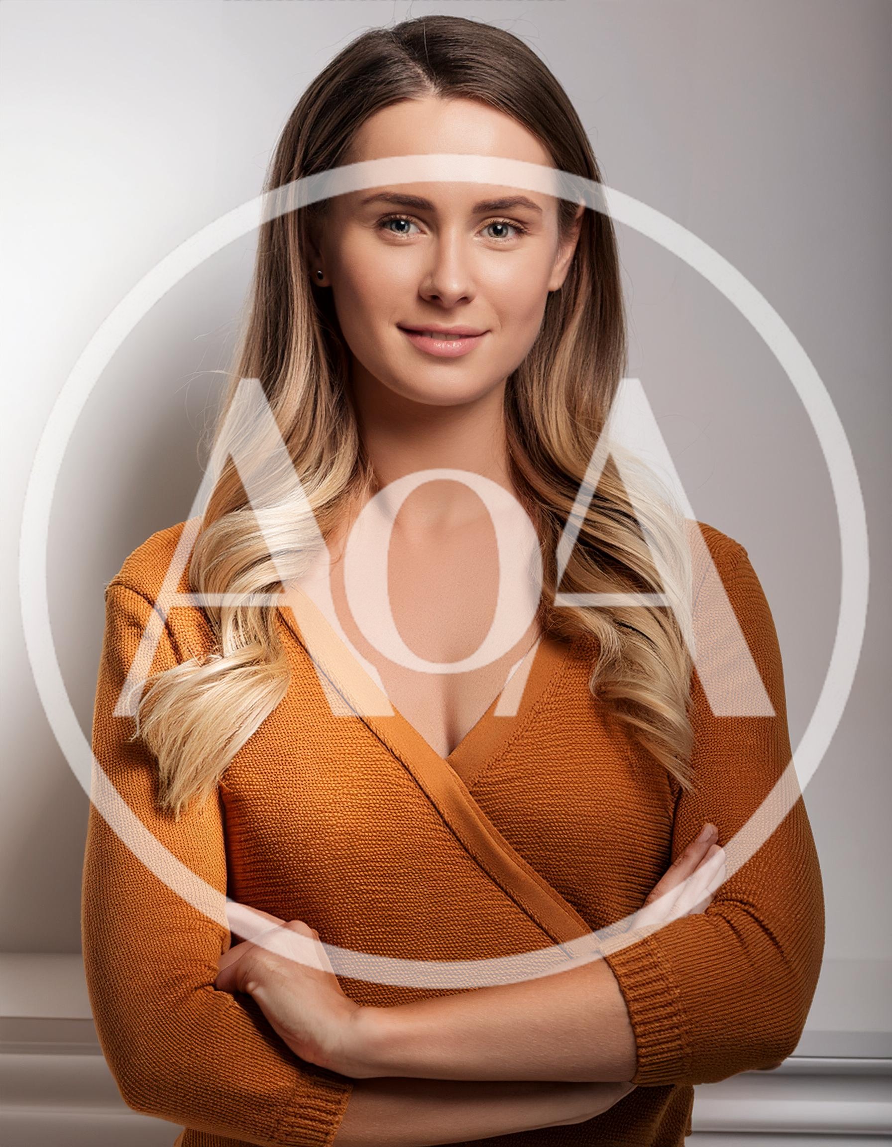 Portrait Of A Confident Woman In An Orange Sweater