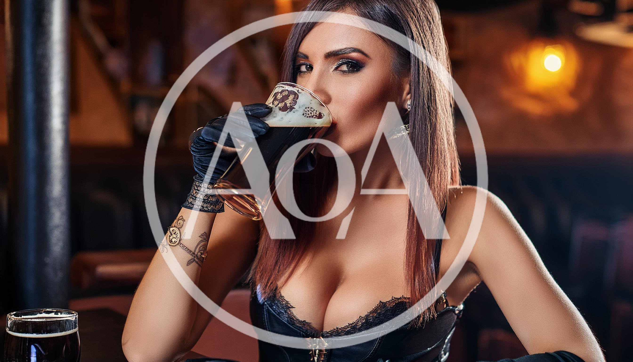 Beautiful Woman Drinking Dark Beer In A Pub