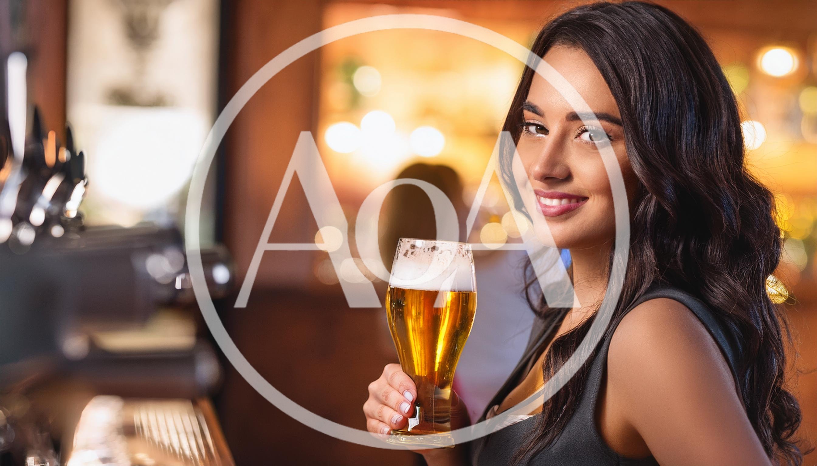 Smiling Woman Holding A Glass Of Beer In A Bar