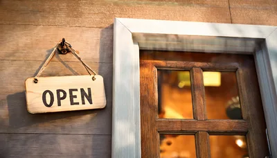 Wooden Open Sign Hanging on a Rustic Shop Door