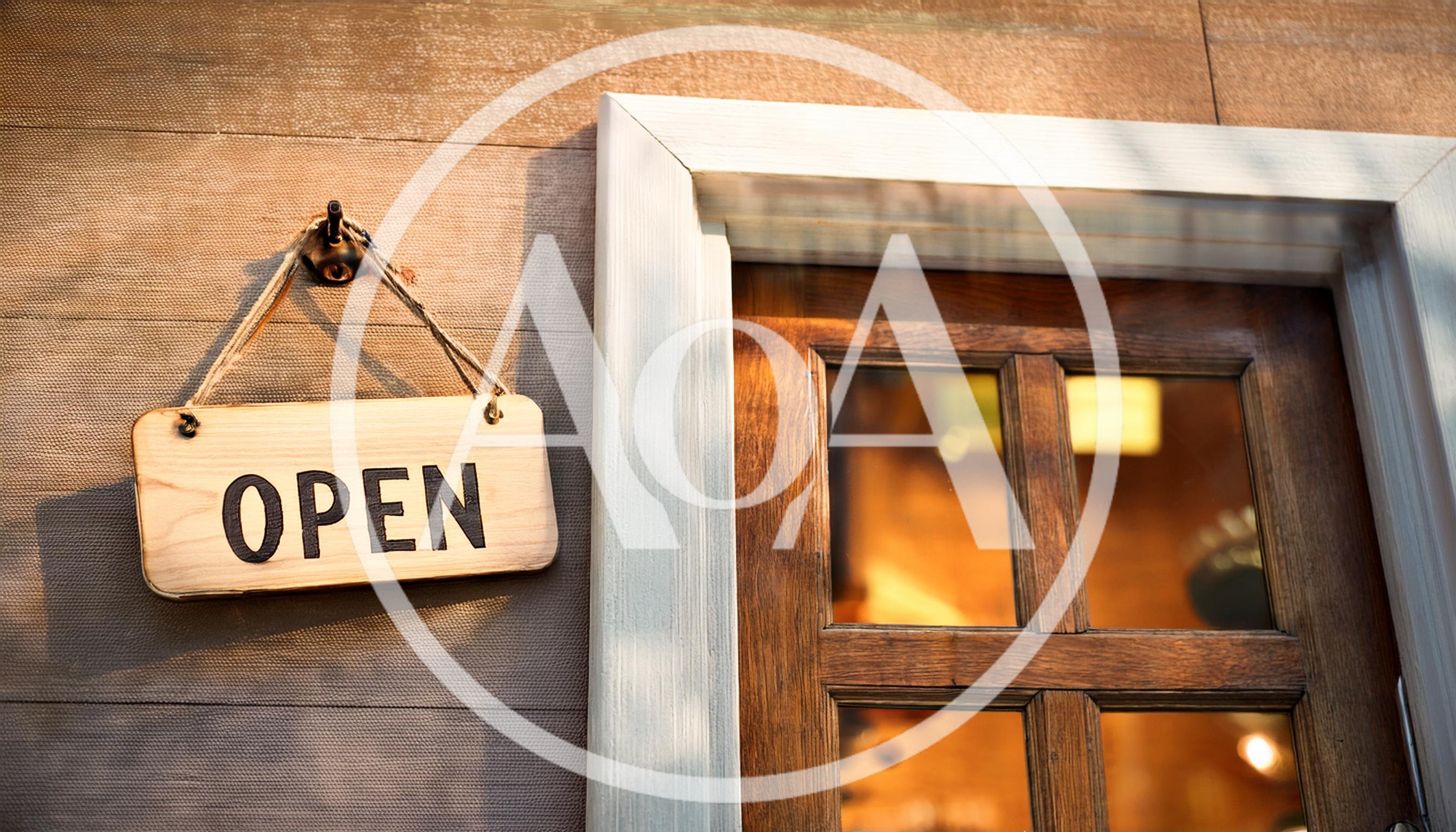 Wooden Open Sign Hanging on a Rustic Shop Door