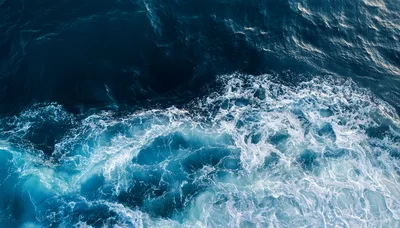 Aerial View Of Ocean Waves And White Sea Foam