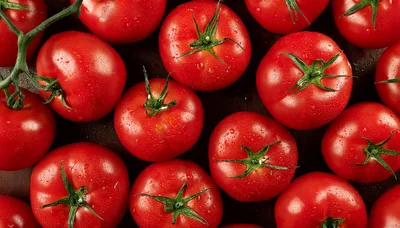 Fresh Red Tomatoes With Green Stems On Dark Background