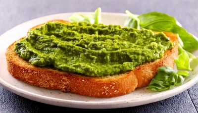 Toasted Bread Slice Topped With Green Pesto Spread