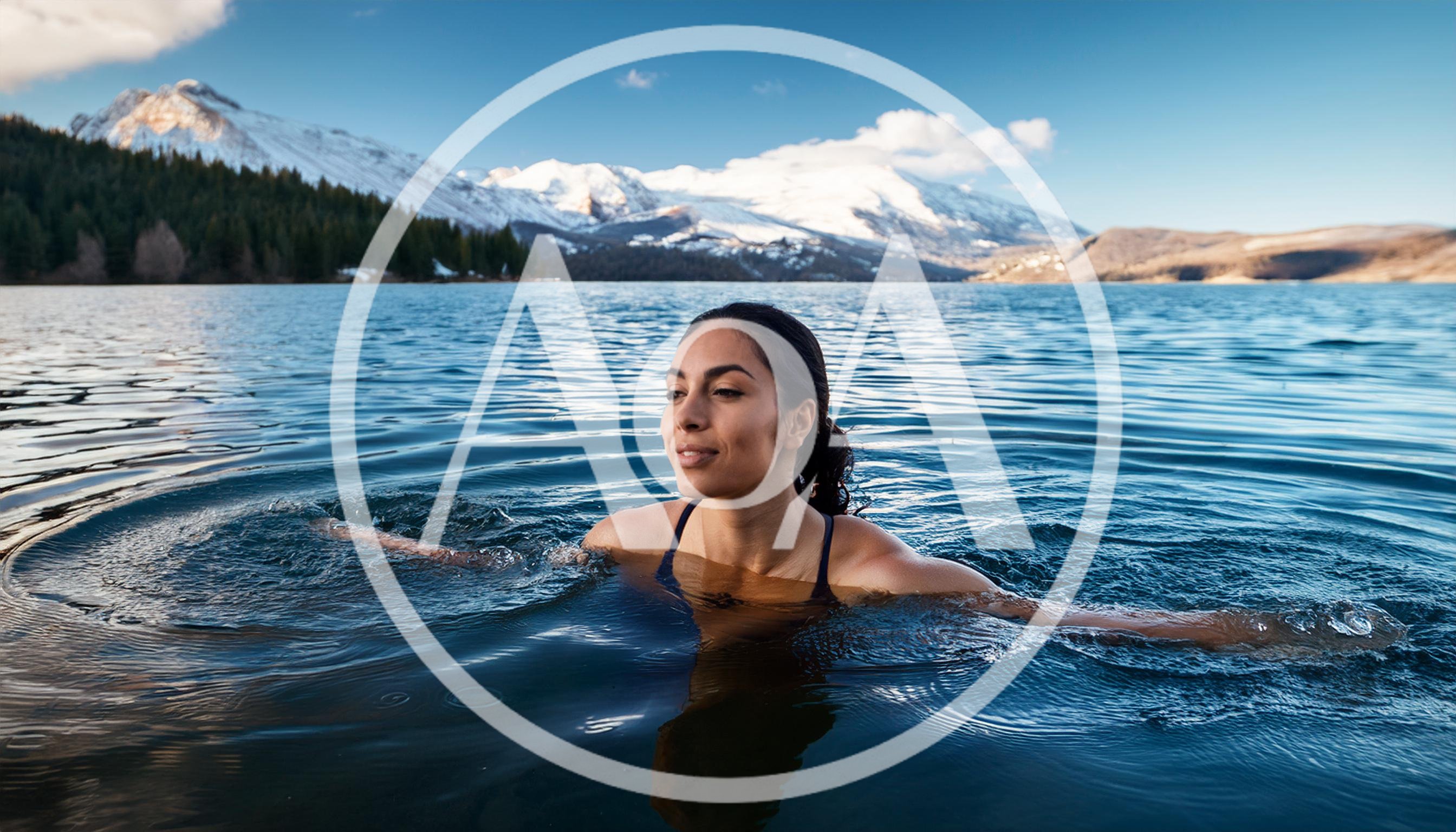 Woman Swimming In A Cold Mountain Lake